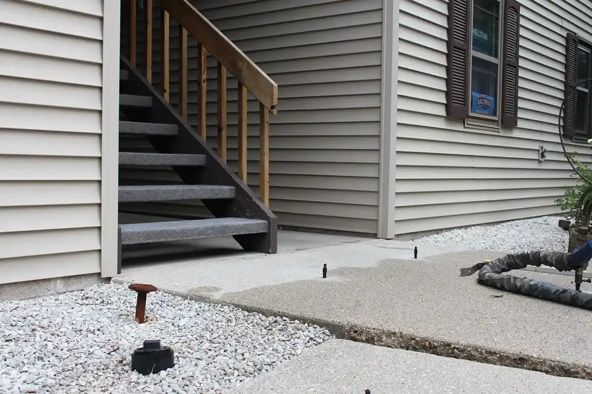 Concrete patio with base and stairs in an apartment complex.
